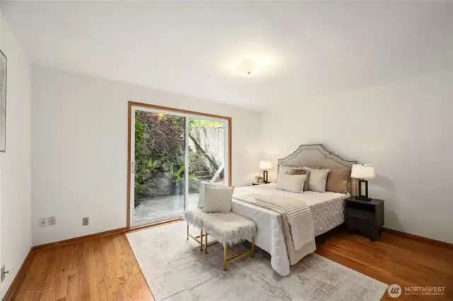 Primary bedroom w/ access to back patio