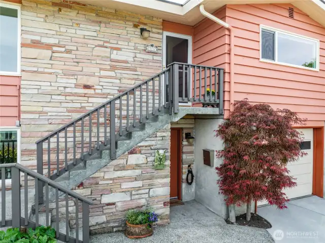Main entrance on top of stairs, separate ground level entrance for basement