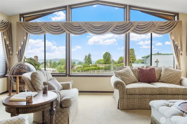 Spacious living room with plush carpet, gas fireplace, & a large picture window great for viewing sunsets.