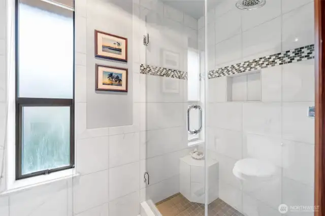 Main floor bathroom with walk in tile shower.