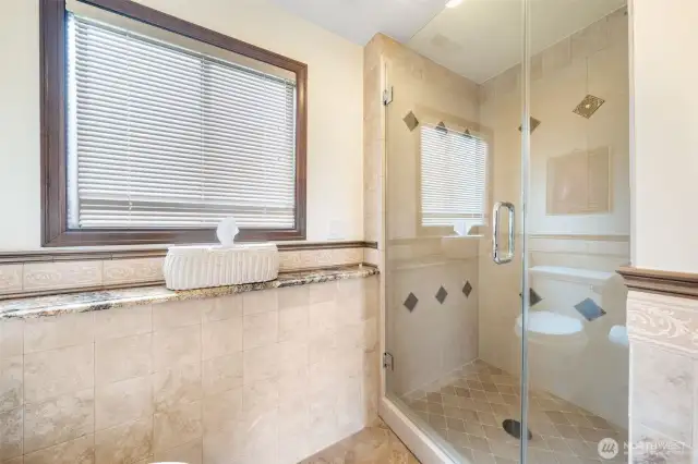 Walk in shower in second primary suite bathroom.