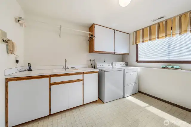 Laundry room with laundry chute, desk and a great space for folding clothes.