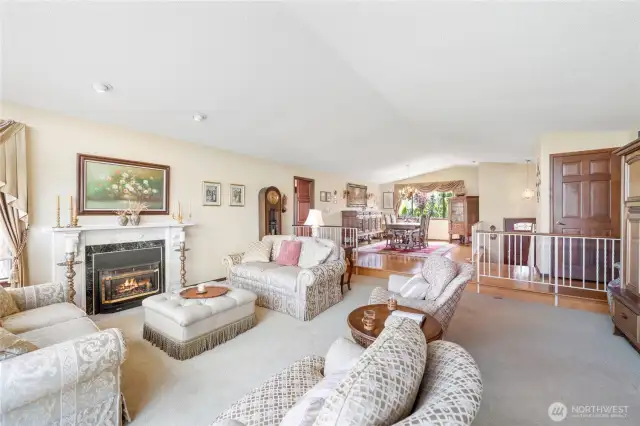 Open concept, living room featuring a large window that allows an abundance of natural light.