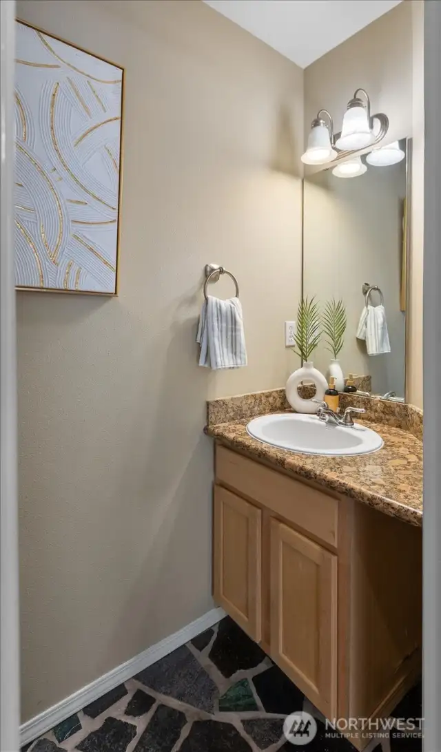 Half Bath off the mainliving space. Granite & Custom Tile.