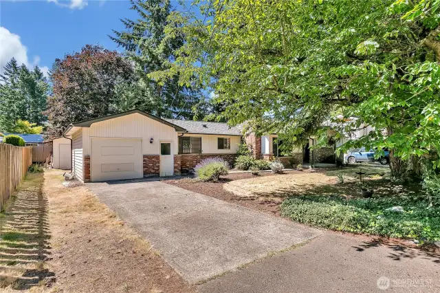 Solidly built rambler with single car garage on large level lot with mature trees and landscaping