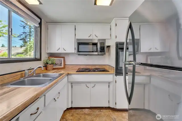 Kitchen includes cooktop, wall oven, microwave and refrigerator
