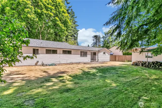 Large level backyard with mature trees