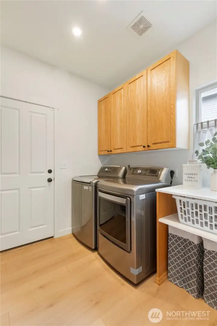 Utility / Mud Room.  A cushioned bench and storage cabinets are to the left.