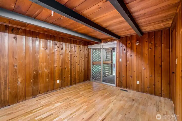 This bedroom likes to keep its options open—slide the glass door to step onto the big front deck, or slip through the other door straight into the full bath. Double closets (not pictured) stand ready for all your treasures, while beams overhead remind you it’s still part of the lodge’s charm.