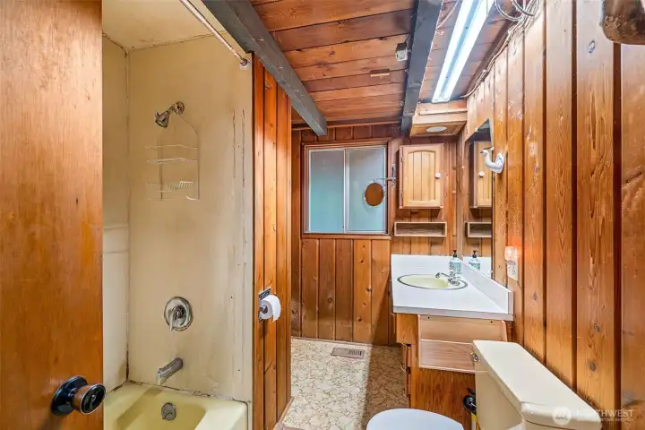 This main bath pulls double duty—accessible from the primary bedroom or the hall. It’s got space and potential, but let’s be honest: it’s ready for a full gut and a glow-up.