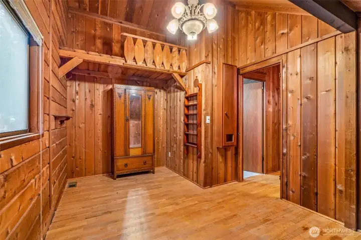 The first bedroom upstairs comes with a few surprises—direct access to the Jack & Jill bath, a walk-in closet hiding a tiny secret door to storage and attic space, and a loft tucked overhead with no way up (yet). Fully wrapped in cedar, it feels like a cozy hideaway with a few mysteries built in.