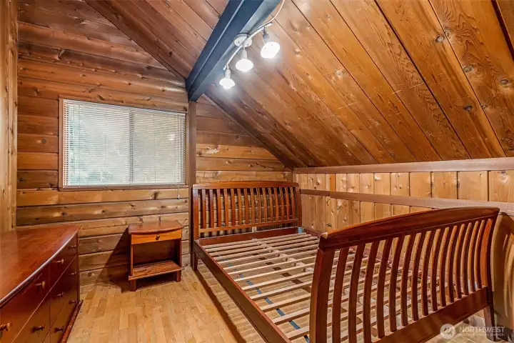 The second bedroom may be smaller, but it comes fully outfitted—bed frame, nightstand, and dresser (don’t worry, no questionable mattress included). A walk-in closet keeps things tidy, while a little door to the attic adds just the right touch of curiosity.