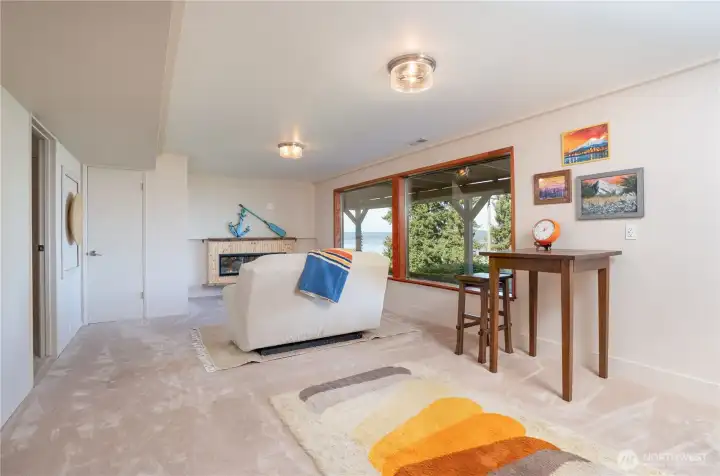 Large living room with Electric fireplace and views from all windows.