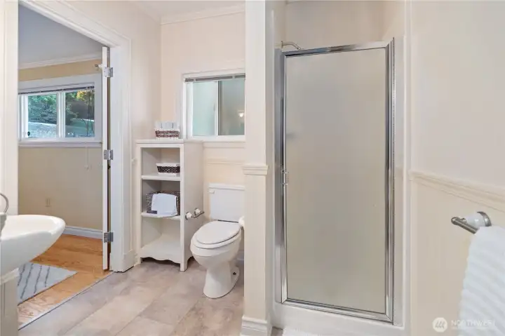 Main floor 3/4 bath w/ access via hallway & bedroom.