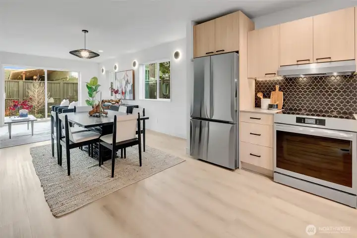 Bright, modern kitchen with soft close cabinets, SS appliances finish a minimalist design.
