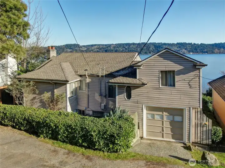 The front of the duplex on Lakeside Ave NE. 1-car garage and 3 parking spots along the front.