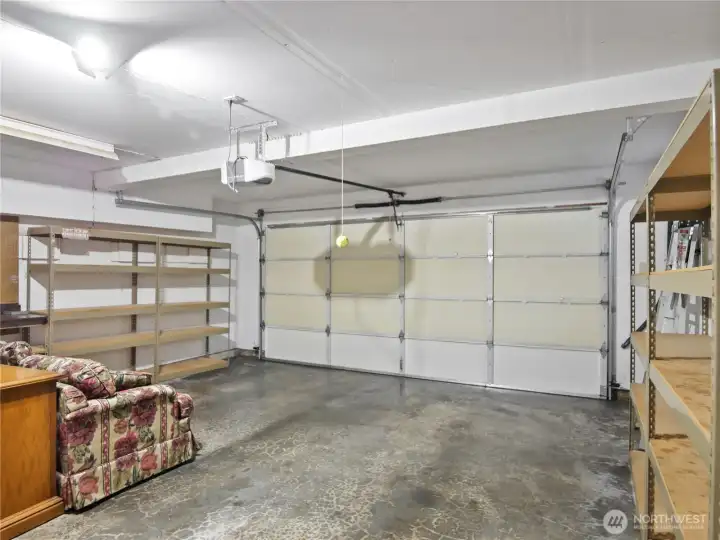 Spacious 2 car garage comes with additional shelving for all your storables.