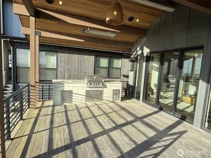 Custom outdoor kitchen with grill, sink and cabinets