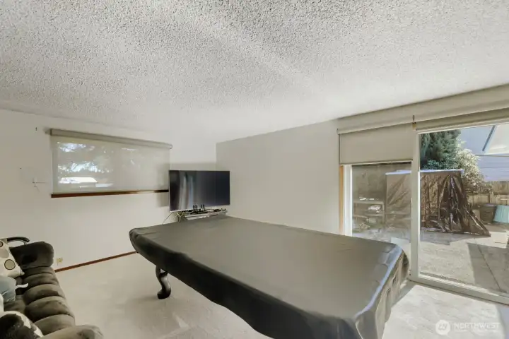 The bonus room invites in the light with windows and a newer slider out to the back yard patio.