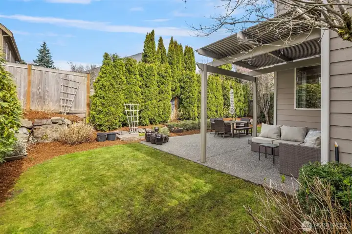 The side yard lawn and garden area, and a lovely pergola over the patio to enjoy