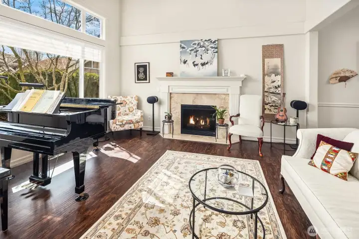You will love this front living room with high ceilings, big dual pane picture windows, and gas fireplace!