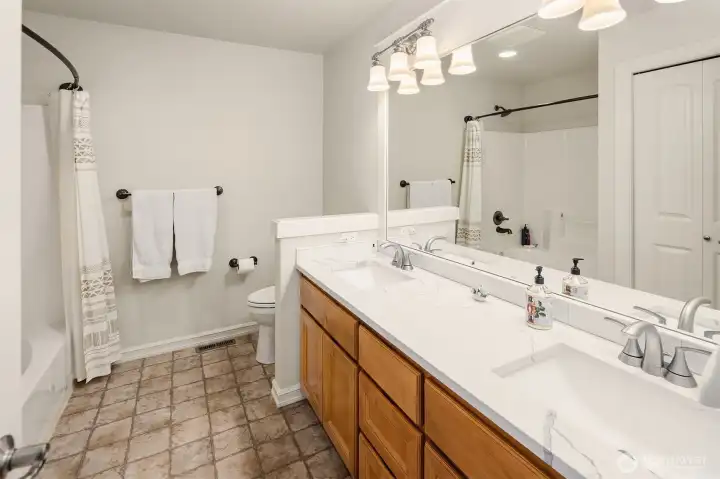 Upstairs Hall Bathroom w/ updated dual sinks & Shower over the tub / Linen Closet