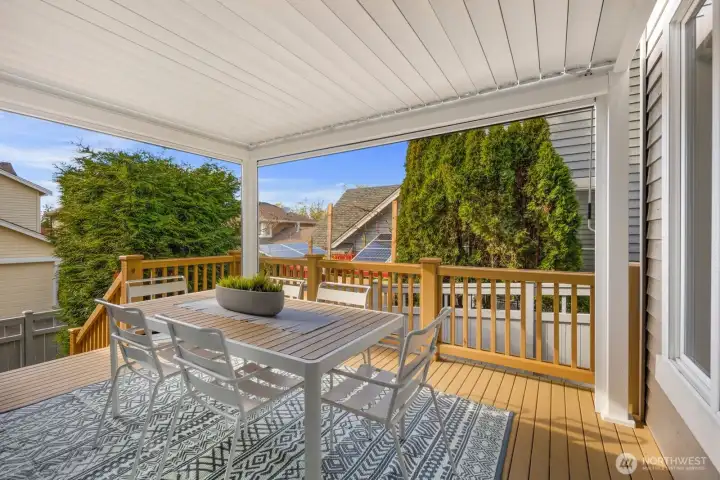 Newly covered back deck.  This pergola has louvers that crank open/shut and two screen that pull down to reduce solar heat and/or wind as well.
