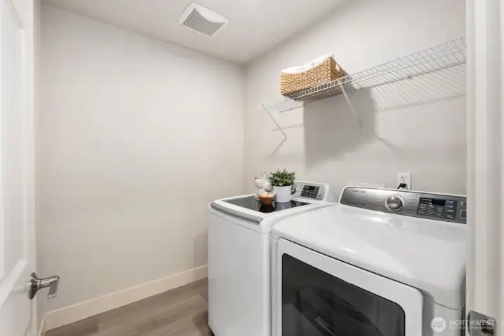 Laundry room, complete with full-size washer/dryer set.