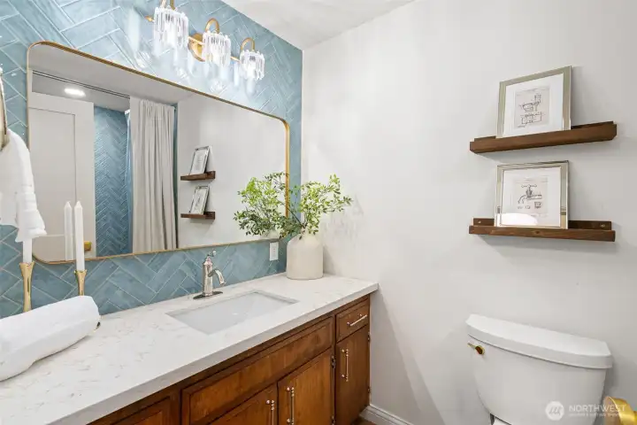 The main bath has a beautiful herringbone tile feature.