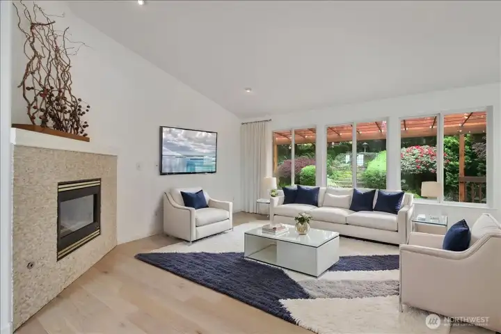Gas insert with mantle and large picture windows looking out backyard to your serene meditation space