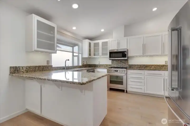 Abundant cabinet space with expansive granite counter tops