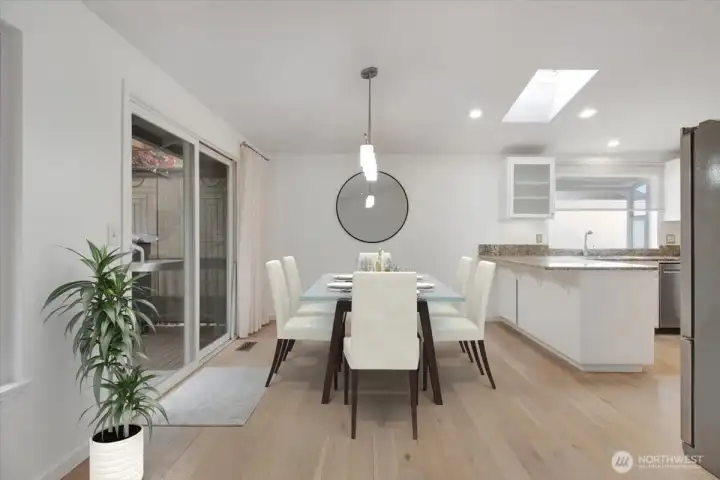 Dining area and sliding patio door to outdoor BBQ and rear covered deck