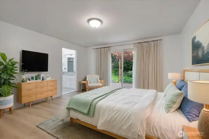 Primary bedroom with walk in closet and private bathroom