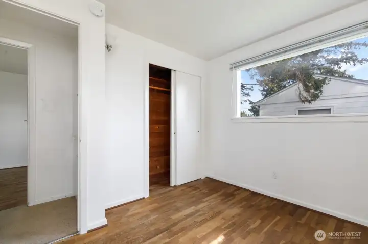 Bed room 1 w/hardwood flooring & cedar closets