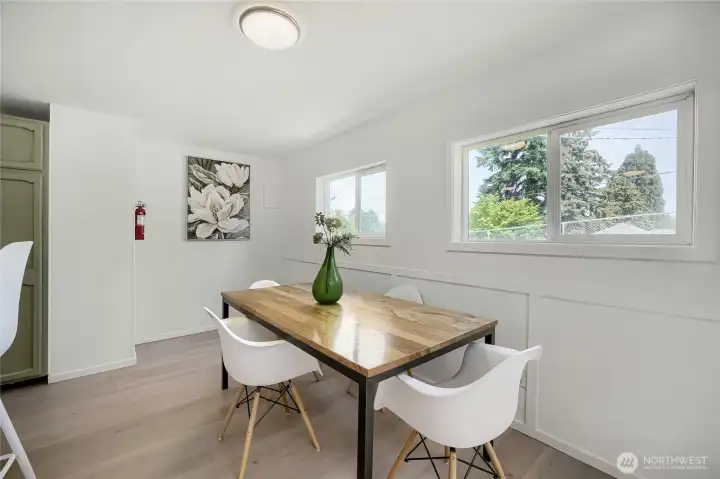 This bright dining space sits just off the kitchen, offering a seamless flow toward the back patio and yard. Sunlight fills the room through multiple windows, creating a warm and inviting atmosphere ideal for everyday meals or casual gatherings. Clean lines and fresh finishes highlight the home’s modern simplicity, while the connection to the outdoor area enhances its open, airy feel—perfect for enjoying Northwest living indoors and out. This bright dining space sits just off the kitchen, offering a seamless flow toward the back patio and yard. Sunlight fills the room through multiple windows, creating a warm and inviting atmosphere ideal for everyday meals or casual gatherings. Clean lines and fresh finishes highlight the home’s modern simplicity, while the connection to the outdoor area enhances its open, airy feel—perfect for enjoying Northwest living indoors and out.