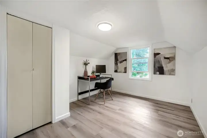 This upper-level room offers flexibility and charm, ideal as a bedroom or home office. Natural light filters through the window, highlighting the fresh white walls and modern flooring. The sloped ceiling adds cozy character, while the built-in closet provides practical storage. Whether used for work, study, or relaxation, this bright space blends comfort and functionality beautifully. This upper-level room offers flexibility and charm, ideal as a bedroom or home office. Natural light filters through the window, highlighting the fresh white walls and modern flooring. The sloped ceiling adds cozy character, while the built-in closet provides practical storage. Whether used for work, study, or relaxation, this bright space blends comfort and functionality beautifully.