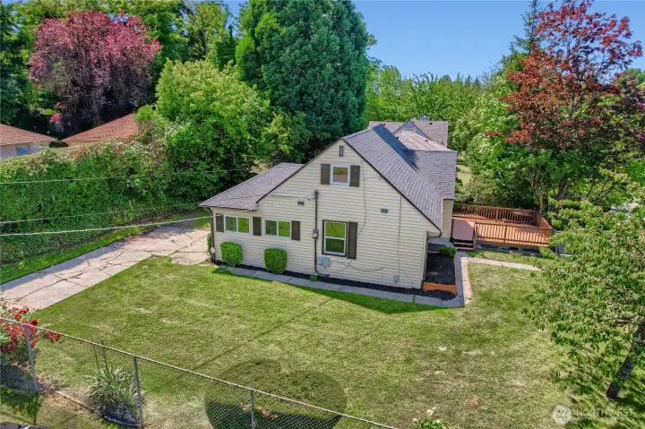 Charming corner-lot home with a fully fenced yard offering space to enjoy outdoor living. Surrounded by mature trees and lush greenery, this property features a well-maintained exterior, a spacious new deck perfect for relaxing or entertaining, and ample driveway parking. The home sits proudly on its lot with a manicured lawn and inviting curb appeal—ideal for those seeking comfort, convenience, and a peaceful neighborhood setting. Charming corner-lot home with a fully fenced yard offering space to enjoy outdoor living. Surrounded by mature trees and lush greenery, this property features a well-maintained exterior, a spacious new deck perfect for relaxing or entertaining, and ample driveway parking. The home sits proudly on its lot with a manicured lawn and inviting curb appeal—ideal for those seeking comfort, convenience, and a peaceful neighborhood setting.