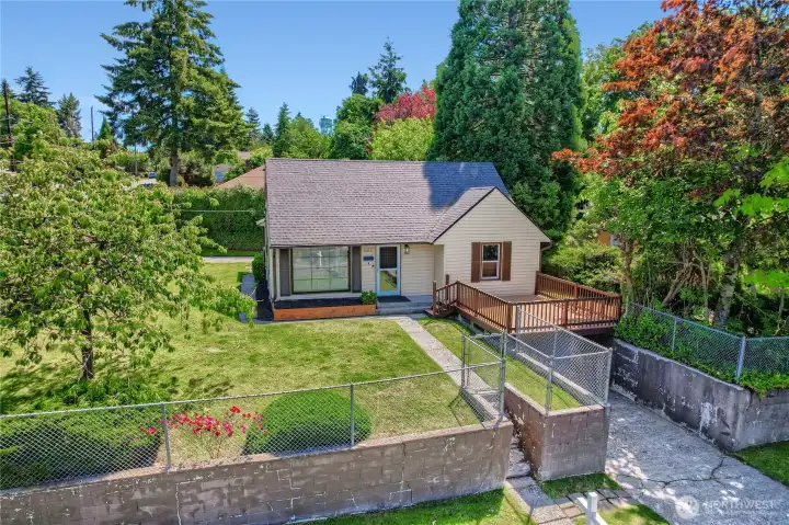 Charming corner-lot home with a fully fenced yard and inviting curb appeal. Surrounded by mature trees and greenery, this well-maintained property features a spacious new deck perfect for relaxing or entertaining. The manicured lawn and open layout create a welcoming outdoor environment, while the home’s classic design and thoughtful updates make it ideal for comfortable everyday living in a peaceful neighborhood setting. Charming corner-lot home with a fully fenced yard and inviting curb appeal. Surrounded by mature trees and greenery, this well-maintained property features a spacious new deck perfect for relaxing or entertaining. The manicured lawn and open layout create a welcoming outdoor environment, while the home’s classic design and thoughtful updates make it ideal for comfortable everyday living in a peaceful neighborhood setting.