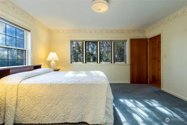 Primary Bedroom with original leaded glass windows. When open you can hear the soothing sounds of Stone Creek outside.