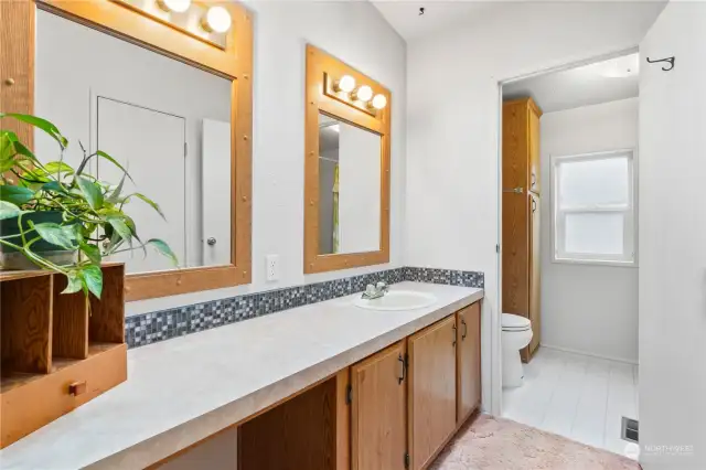 Primary Bedroom w/Extra Long Vanity, two mirrors, cabinets.