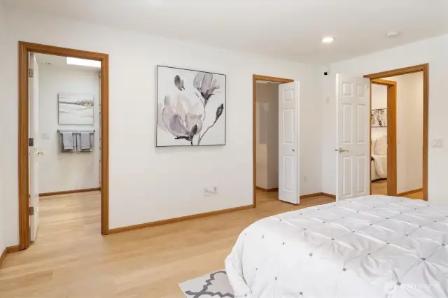 Primary bedroom features a walk-in closet with built-in shelves, and an en-suite bathroom featuring a double sink and walk-in shower.