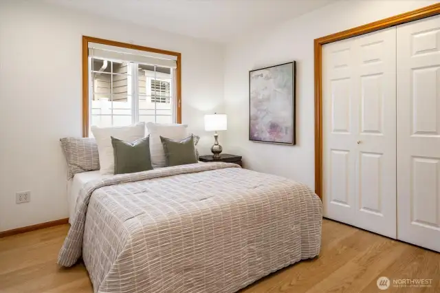 Bedroom 1: A light and bright, spacious room equipped with custom closet organizers and window coverings.