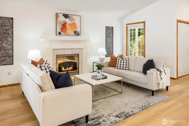 The elegant gas fireplace, framed by a wood mantle and millwork, adds warmth and charm.