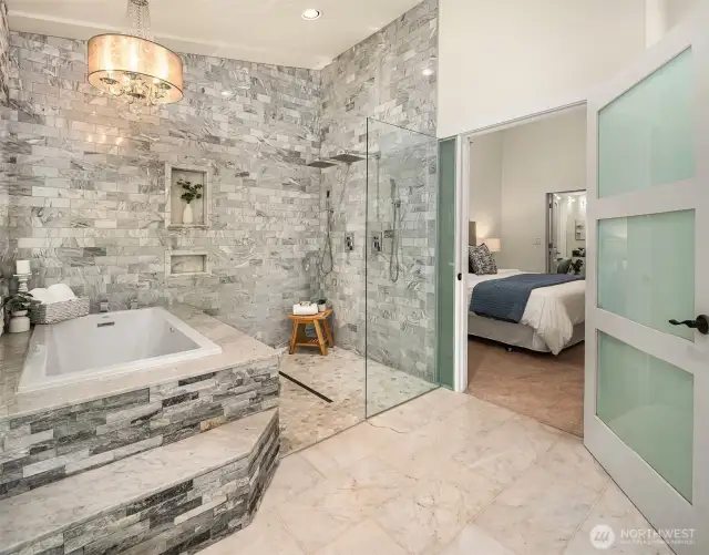 Owner Suite bathroom with marble floors, jetted tub, 2 shower heads, 2 sinks & french doors to the backyard/dog wash station