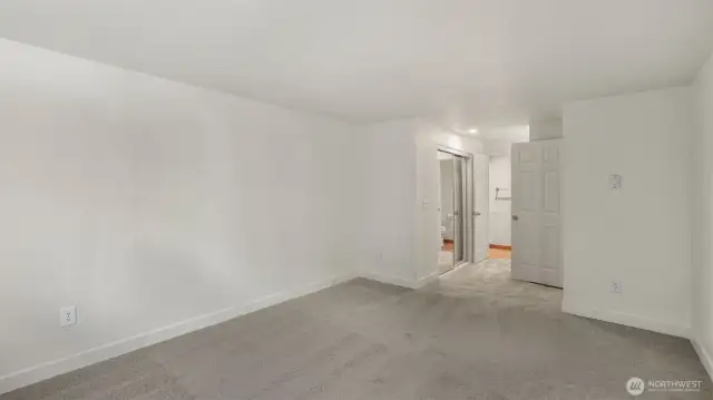 Another angle of your Primary Suite showcasing the large closet, recessed lighting and 3/4 bath.