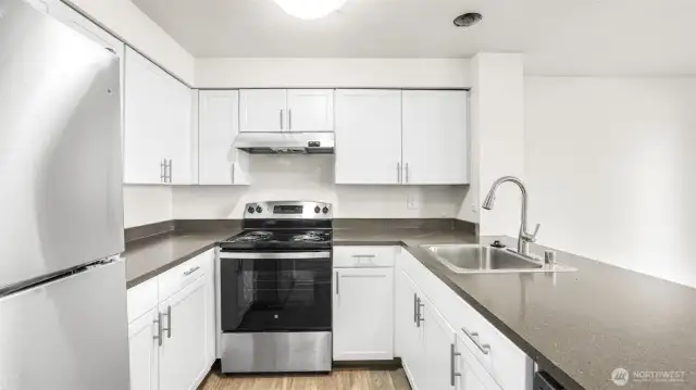 White shaker cabinetry, sleek countertops, plenty of storage & all appliances stay.