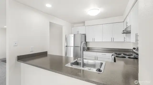 Another angle of this galley style kitchen showcases the flow as well as the light & bright feel.