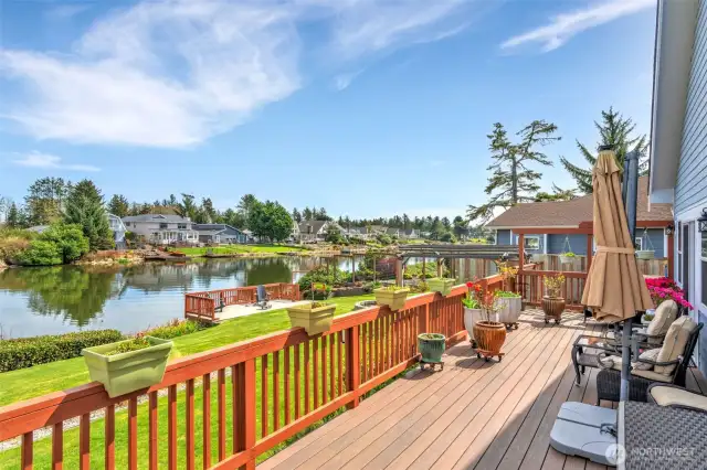 Oooh la la! The deck is expansive and runs the entire length of the back of the house. You can access it from both the primary suite and living room. A great place to relax, read a book or have morning coffee.  Over looking Duck Lake.
