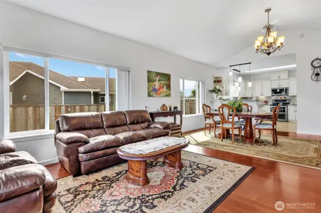 The living room carries natural light all the way through to the dining room and kitchen. A great gathering space for guests or holiday occasions.