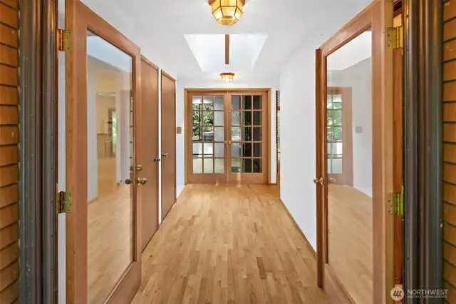 Double door front entry with French doors to the living room in the background.